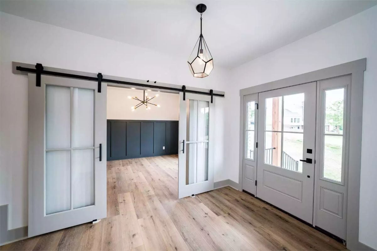 Sliding Barn Doors With Frosted Glass Panels Make This Entryway Work Harder