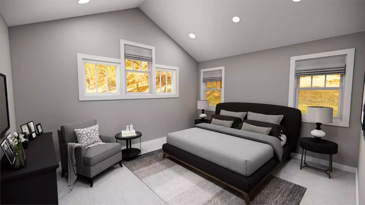 Vaulted Ceiling and a Dark Bed Frame That Anchor the Whole Room