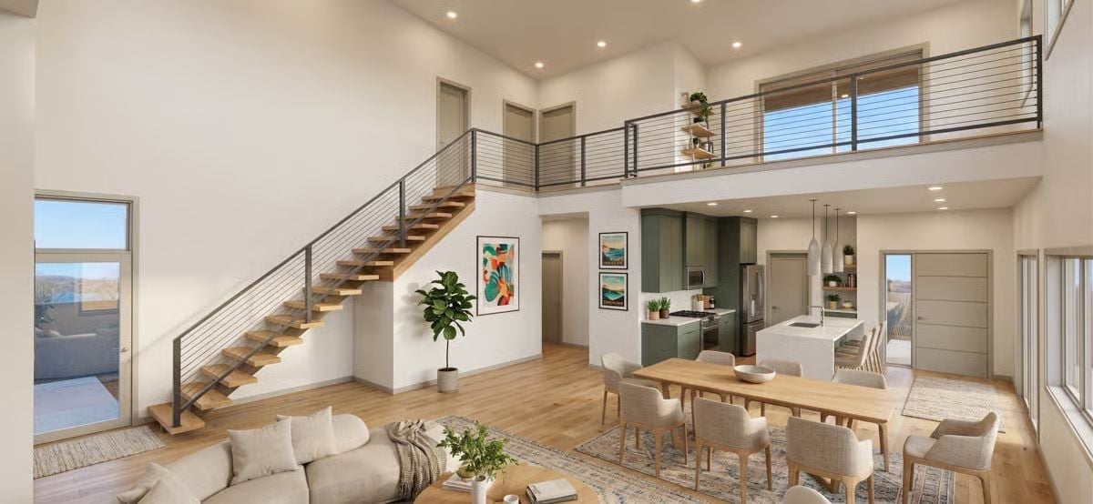 Double-Height Living Gets Grounded by Sage Cabinets and Warm Wood Treads