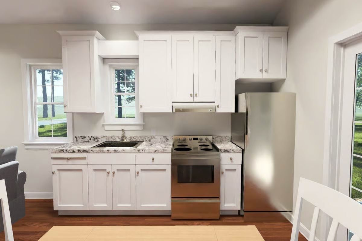 Stainless Appliances and a Granite Sink Wall Do the Heavy Lifting Here