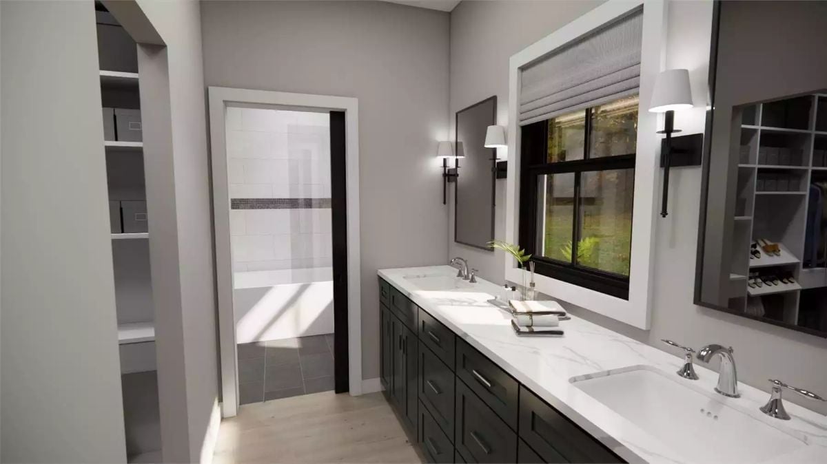 Dark Vanity Cabinets and Marble Counters Pull This Primary Bath Together