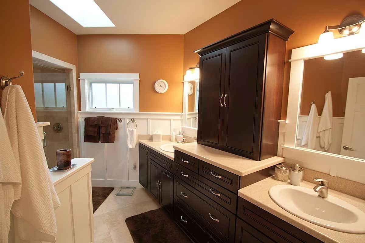 Dark Cabinetry and Warm Walls Make a Strong Case for Ditching White Bathrooms