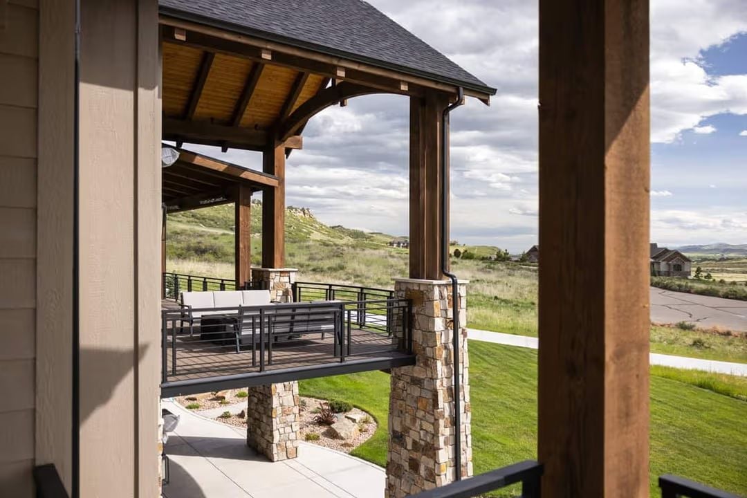 Covered Deck with Stone Columns Built for a View Worth Coming Home To