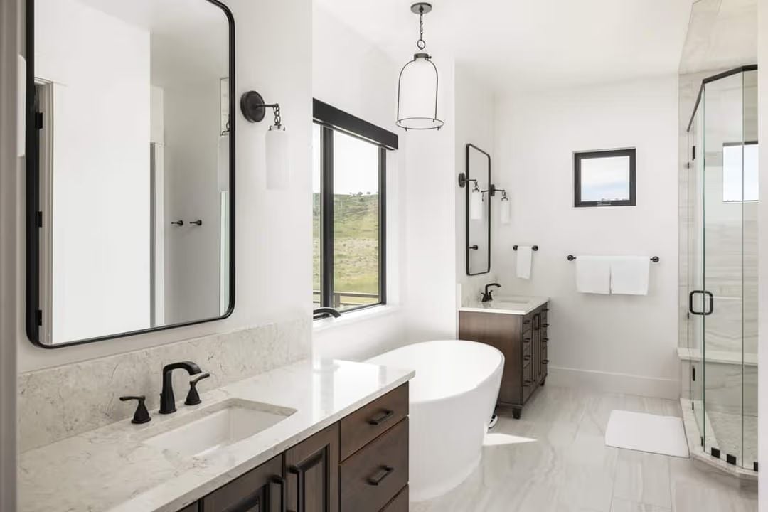Matte Black Hardware Ties Two Vanities and a Freestanding Tub Into One Cohesive Bathroom