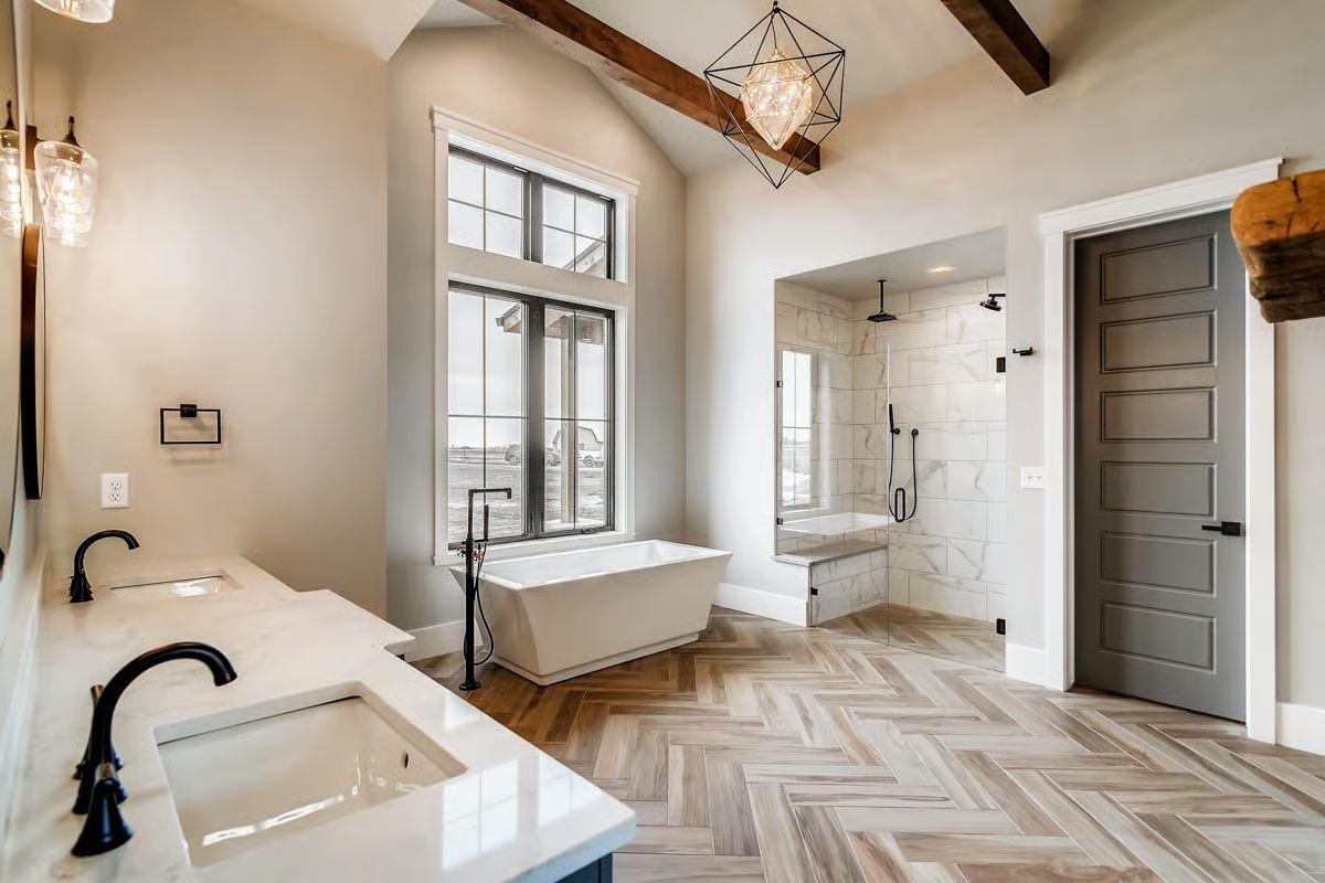 Herringbone Floor and a Freestanding Tub Positioned to Catch Every Bit of Natural Light