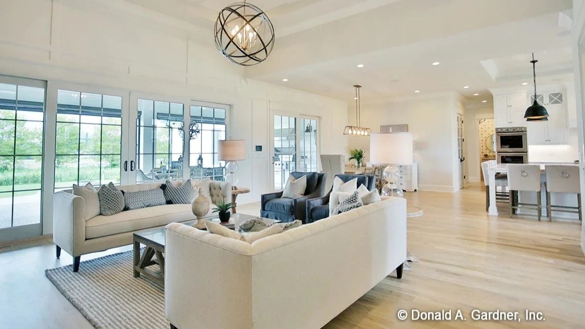 Orb Chandelier, Light Wood Floors, and a Living Room That Earns Its Square Footage