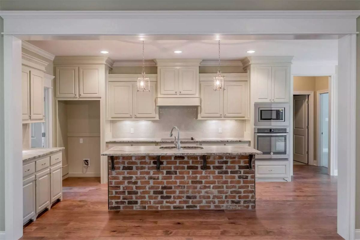 Brick Island Base in a Cream Kitchen That Earns the Contrast