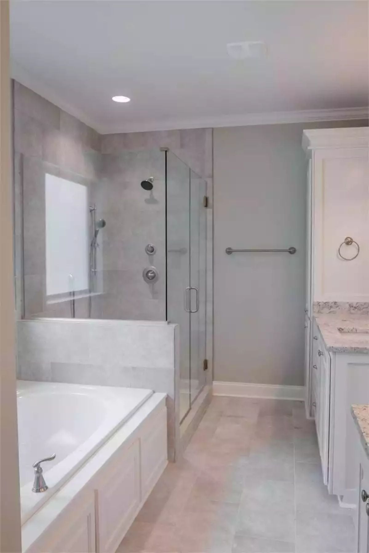 Soaking Tub Beside a Glass Shower Where Neither Competes for Attention