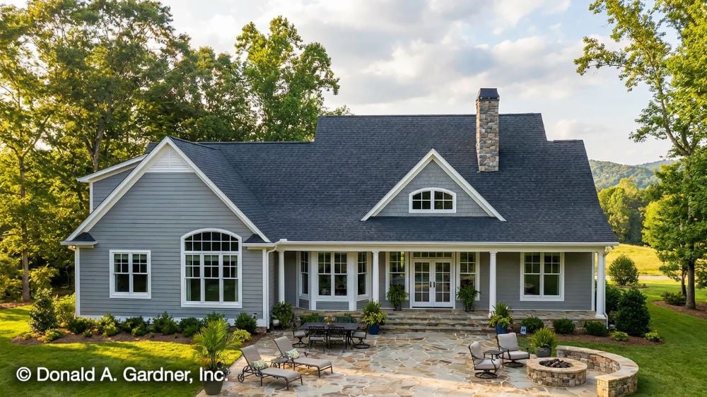Gray Siding, Stone Chimney, and a Patio That Earns Its Square Footage