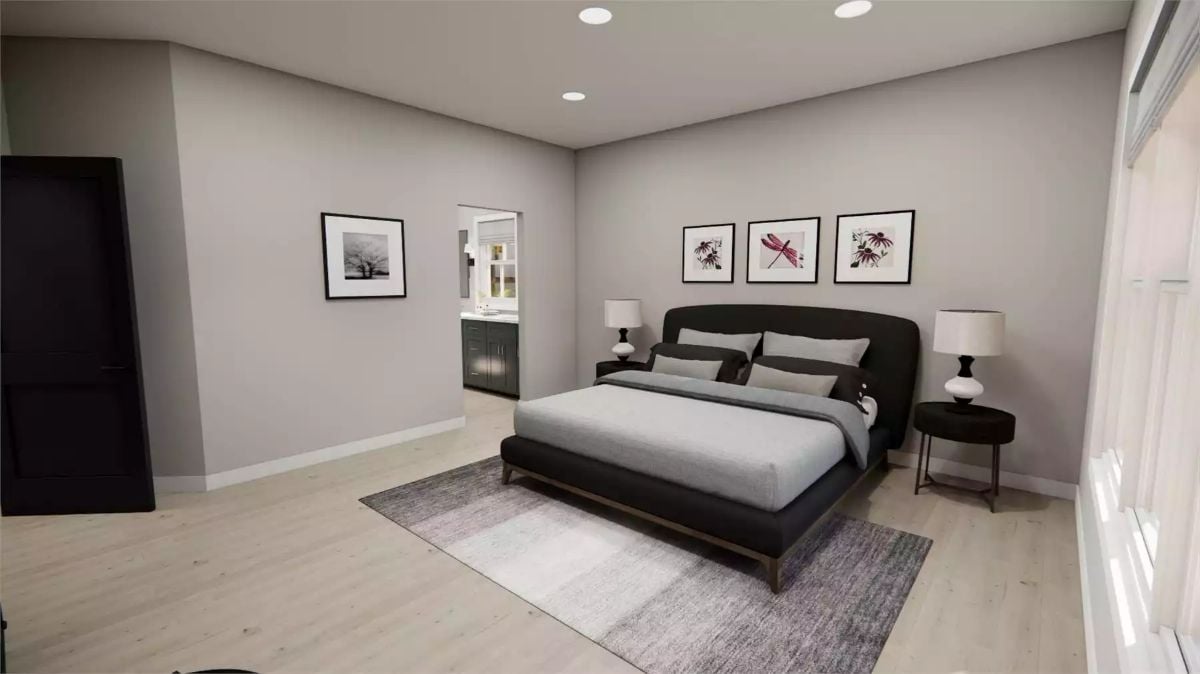 Dark Headboard, Three Frames, and a Door That Opens Straight Into the Bath