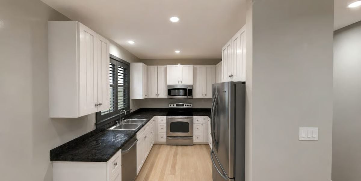 Dark Granite Counters Against White Shaker Cabinets Do the Heavy Lifting Here