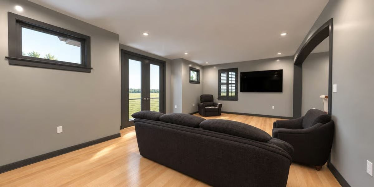 Dark Sofas, Light Floor, and a TV Wall That Keeps Things Simple
