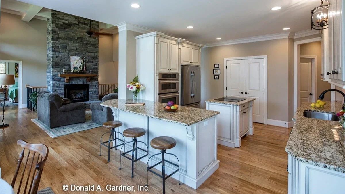 Granite Counters, Three Bar Stools, and a Fireplace You Can See From the Sink