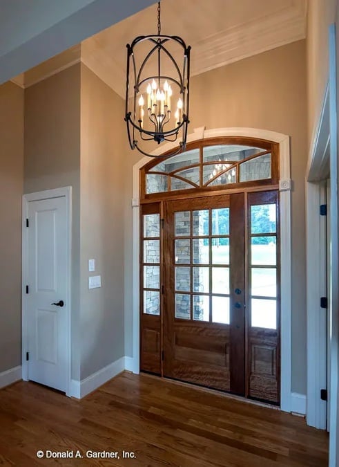 Wrought Iron Lantern Chandelier Anchors a Foyer Built to Impress