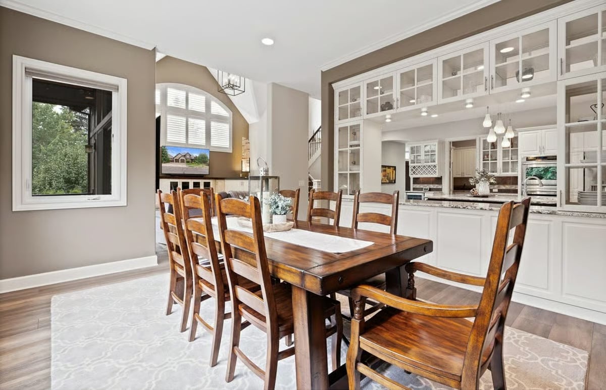 Ladder-Back Chairs and Glass Cabinetry That Make the Kitchen Feel Like Part of the Party
