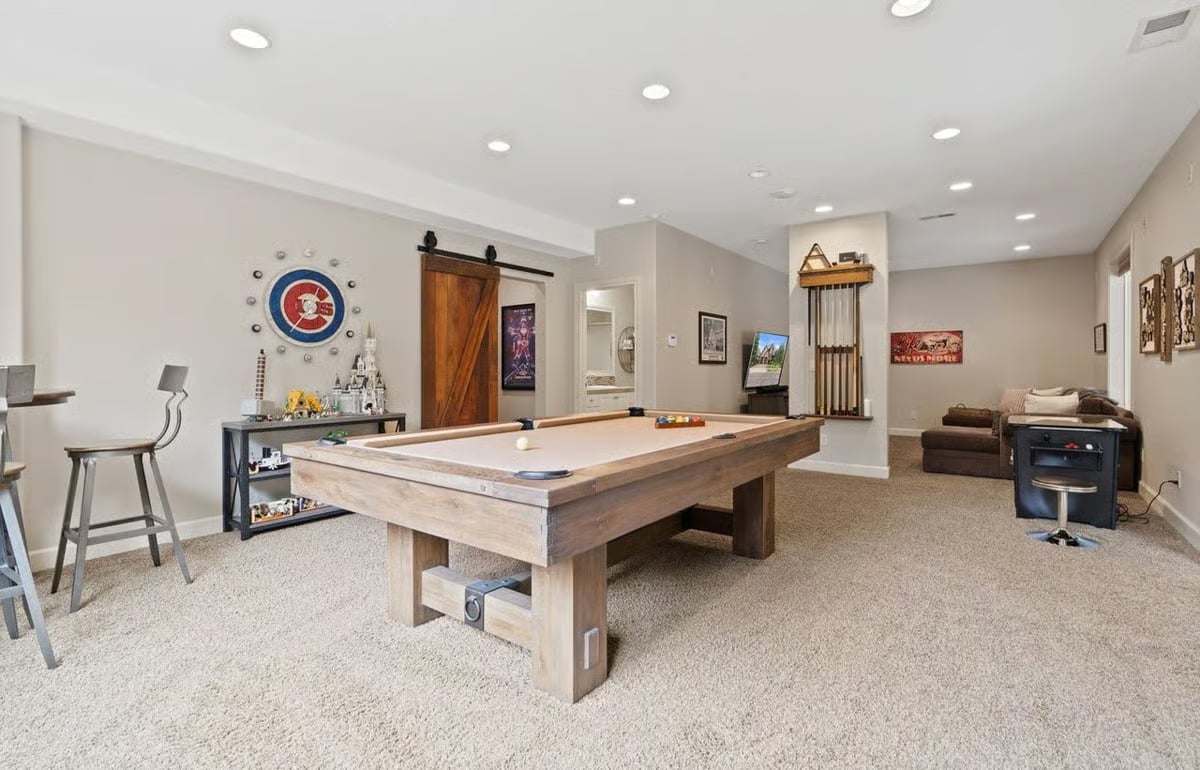 Pool Table, Cue Rack, and a Cubs Wall Clock That Tell You Exactly Who Lives Here