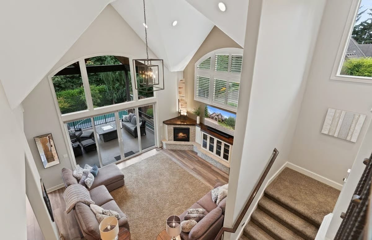 Vaulted Great Room Where the Corner Fireplace and Deck Views Compete for Attention