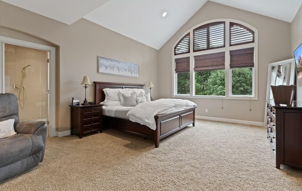 Vaulted Master Suite Where the Arched Window Pulls All the Attention