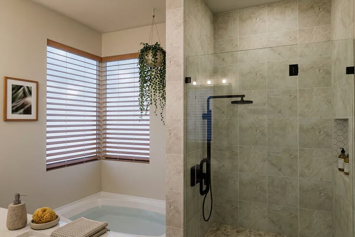 Matte Black Fixtures, Marble Tile, and a Soaking Tub That Minds Its Own Business