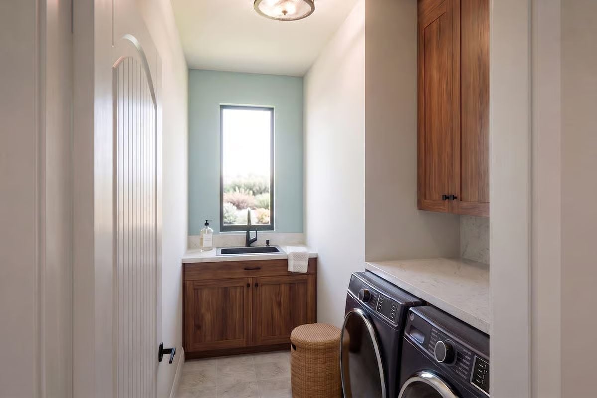 Sage Wall, Walnut Cabinets, and a Laundry Room Worth Lingering In
