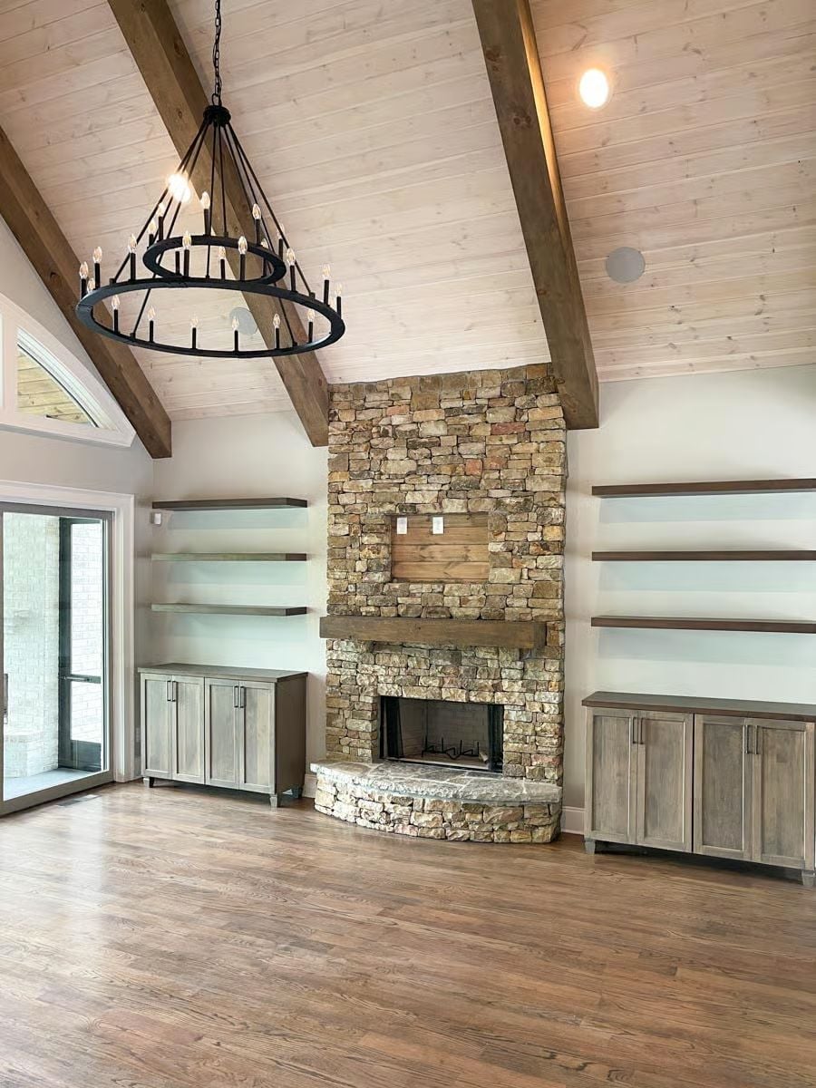 Stone Fireplace Tower, Exposed Beams, and Floating Shelves Built to Fill the Wall