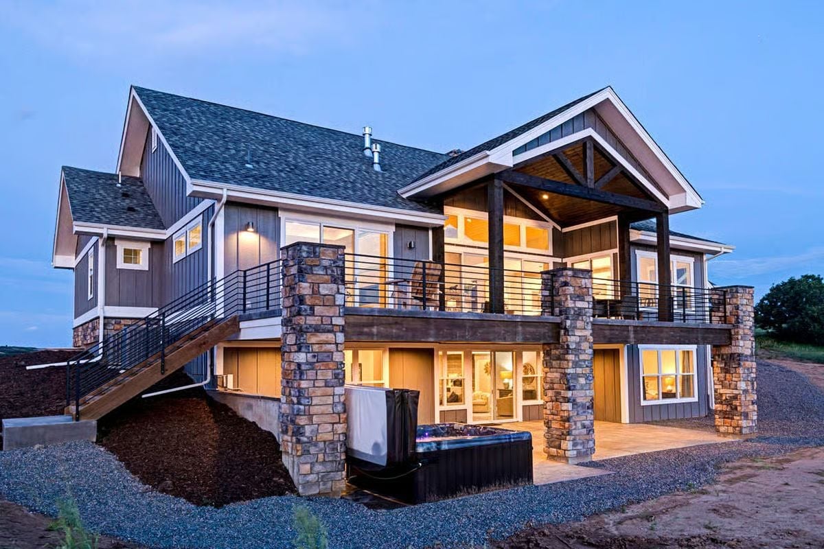 Covered Gable Porch and Stone Columns Frame a Back Exterior Built for Evening Gatherings