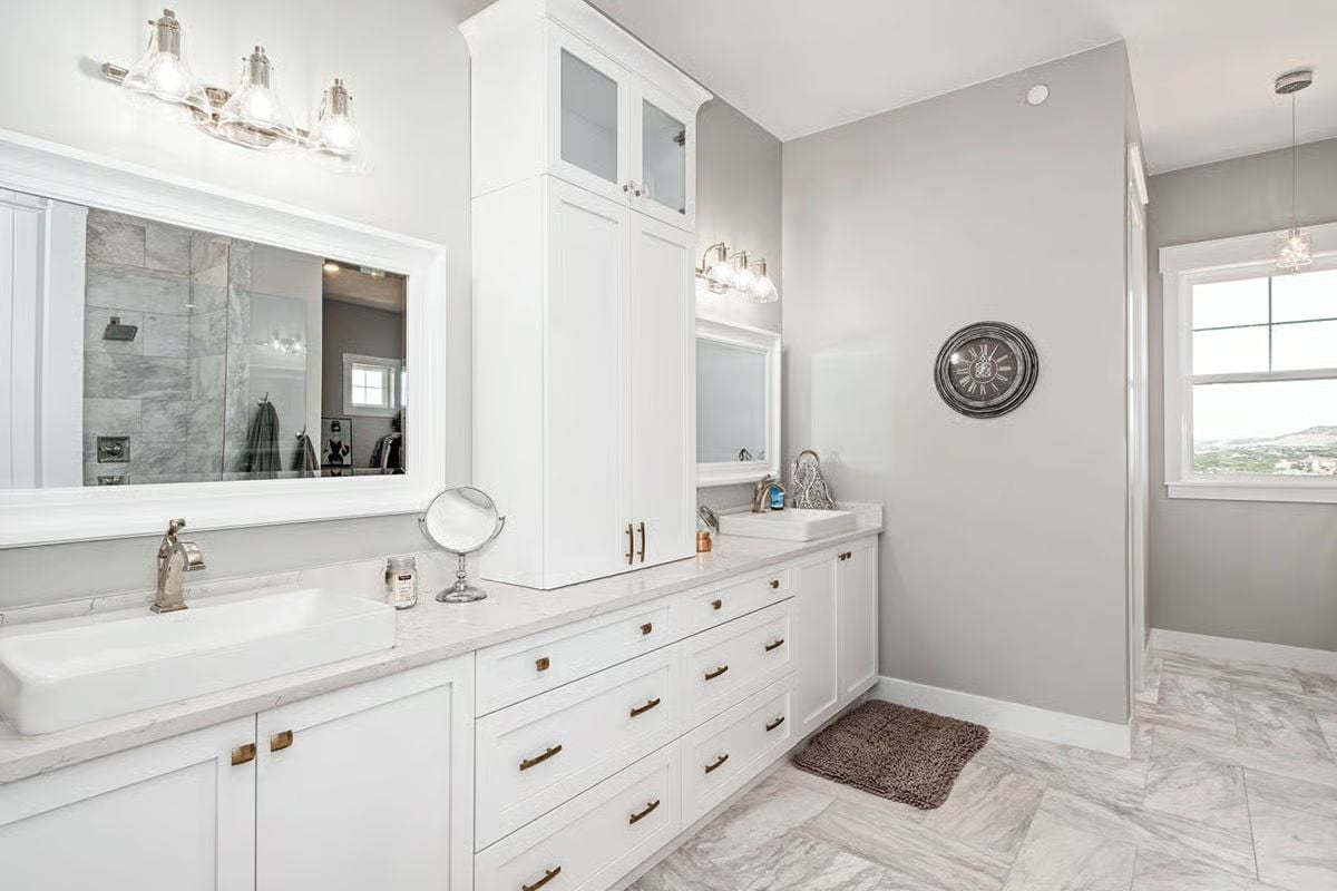 Dual Vanities Split by a Tower Cabinet Keep Two Routines from Colliding
