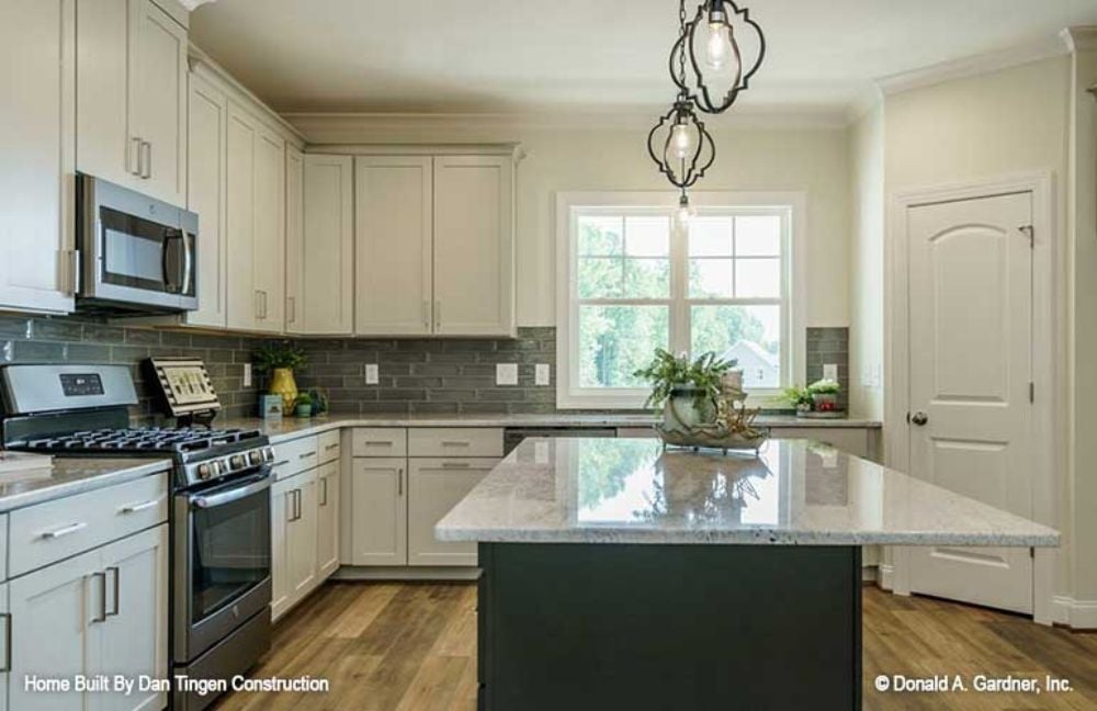 Slate Backsplash, Dark Island Base, and Pendant Lights Worth Noticing