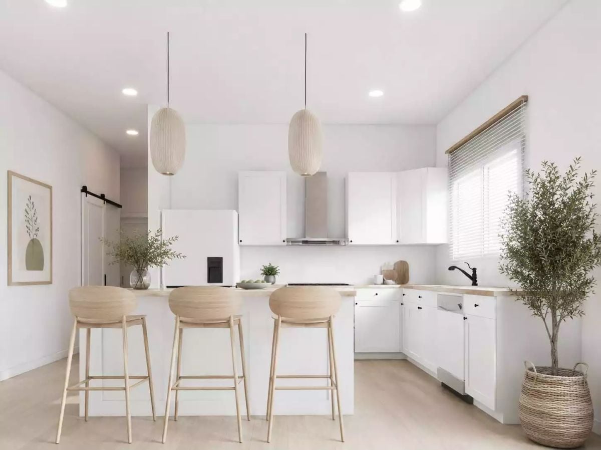 White Cabinets, Wood Stools, and a Kitchen That Earns Its Calm