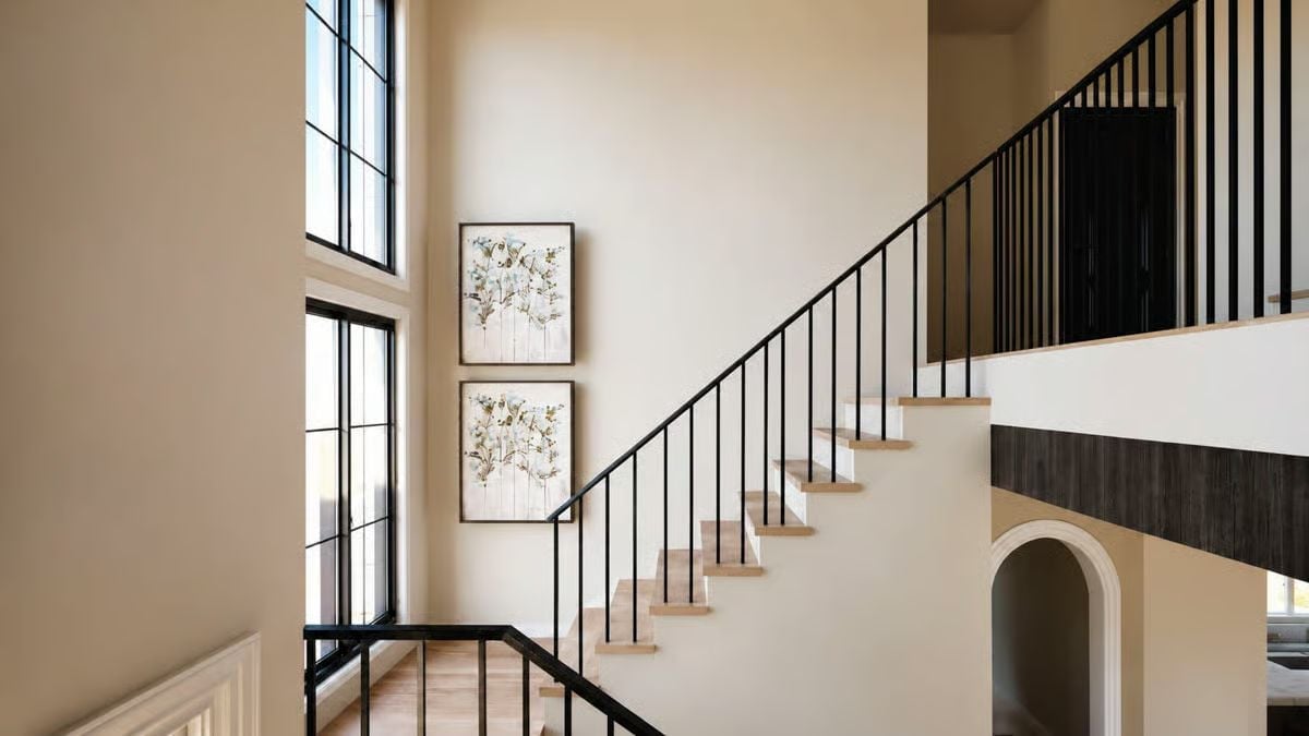 Black Steel Balusters and Paired Botanicals Make the Staircase Worth Slowing Down For