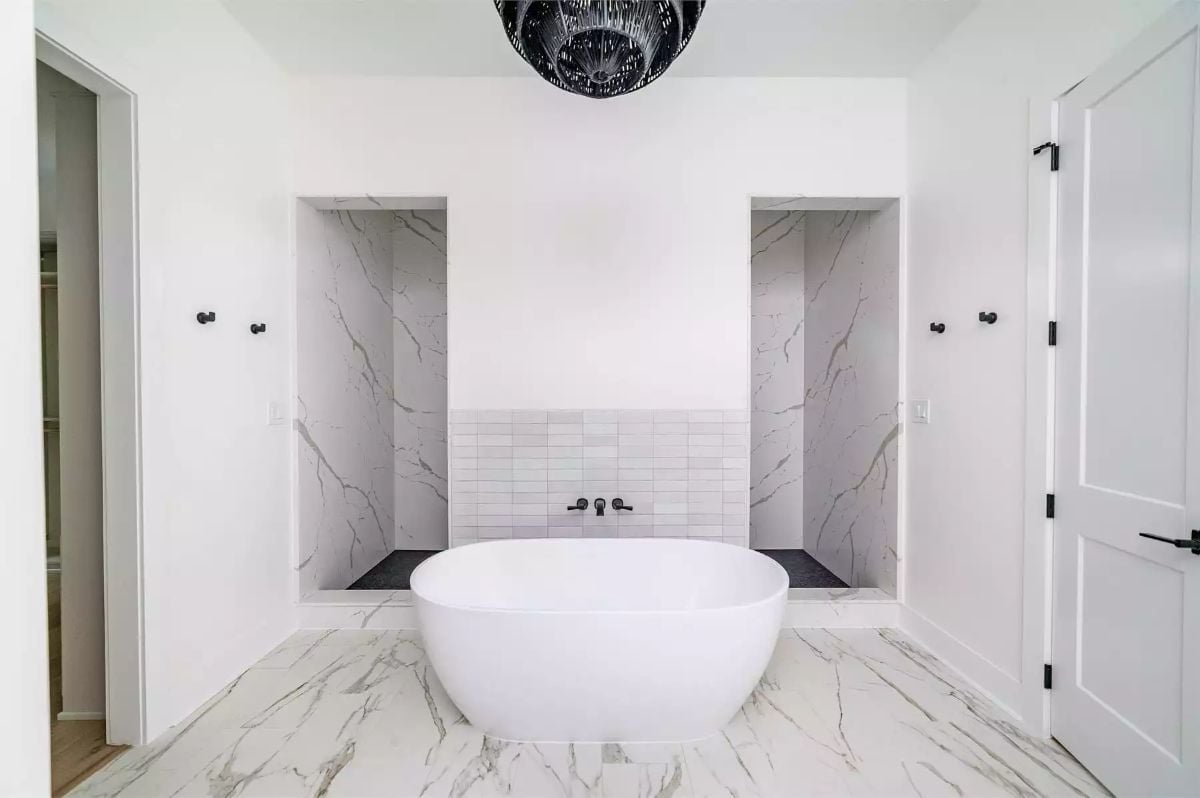 Freestanding Tub Centered Between Two Marble Shower Niches That Frame It Perfectly