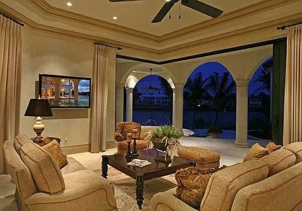 Arched Colonnades, Ceiling Fan Shadows, and a Living Room That Opens to the Water
