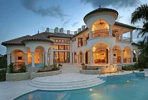 Curved Tower, Lit Arches, and a Pool That Wraps Around the Whole Thing