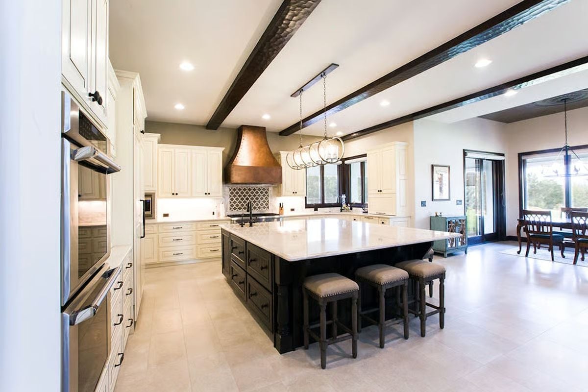 Copper Range Hood Over a Dark Island Built to Handle Real Cooking