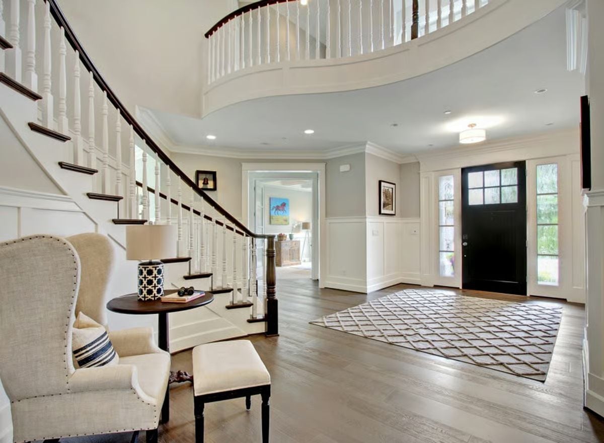 Curved Balcony, Dark Treads, and a Front Door That Means Business