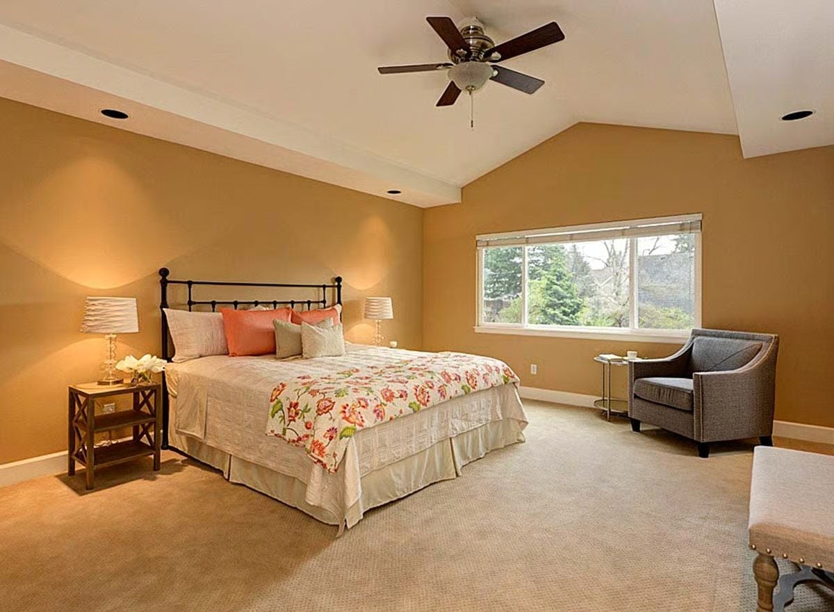 Warm Gold Walls and a Wrought Iron Headboard That Set the Whole Tone