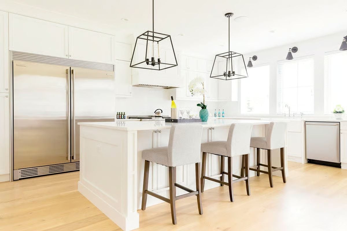 Cage Pendants, White Paint, and a Kitchen Island That Holds Its Ground