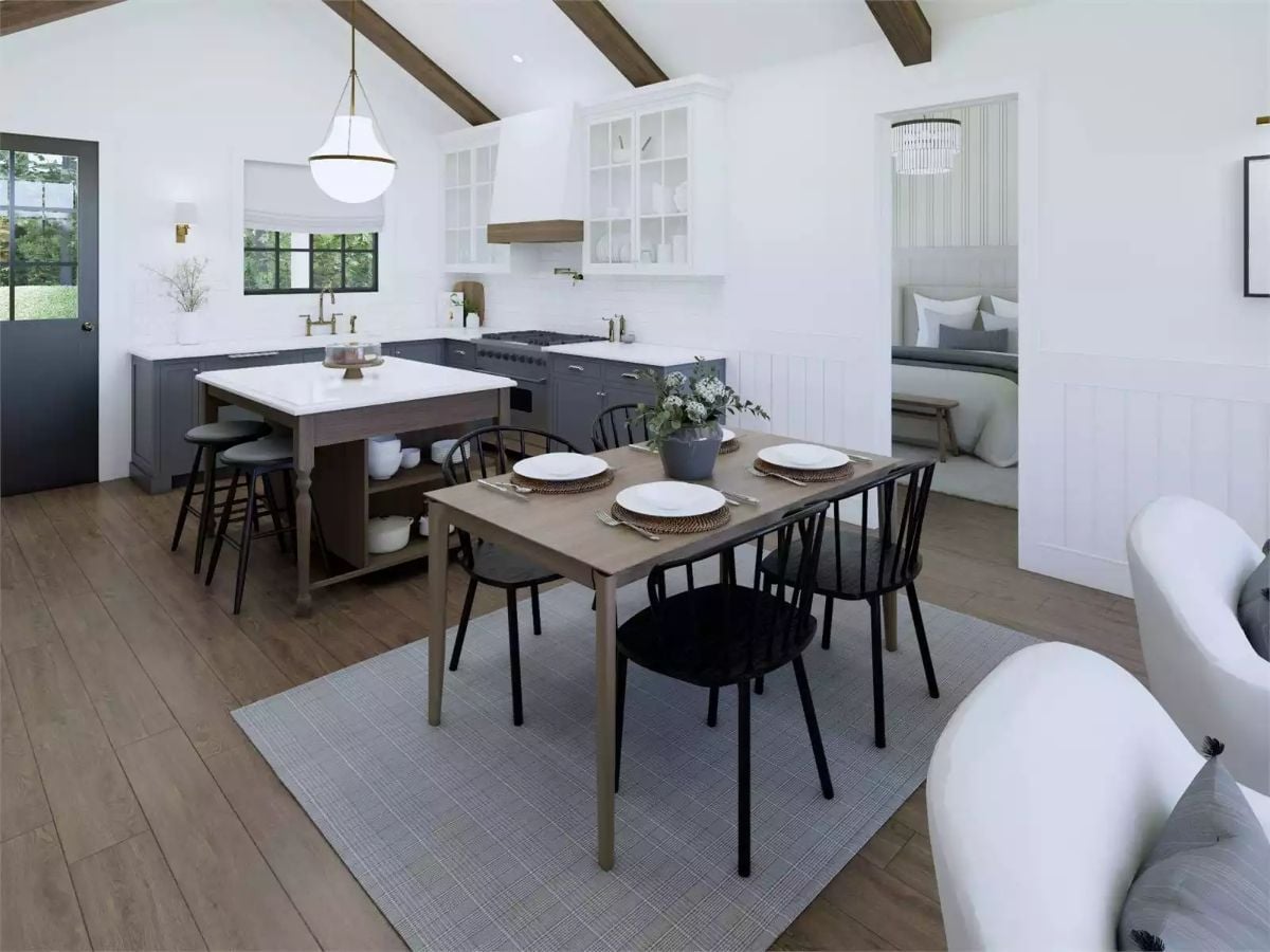 Open-Plan Kitchen Where Dark Cabinets and White Counters Do the Heavy Lifting