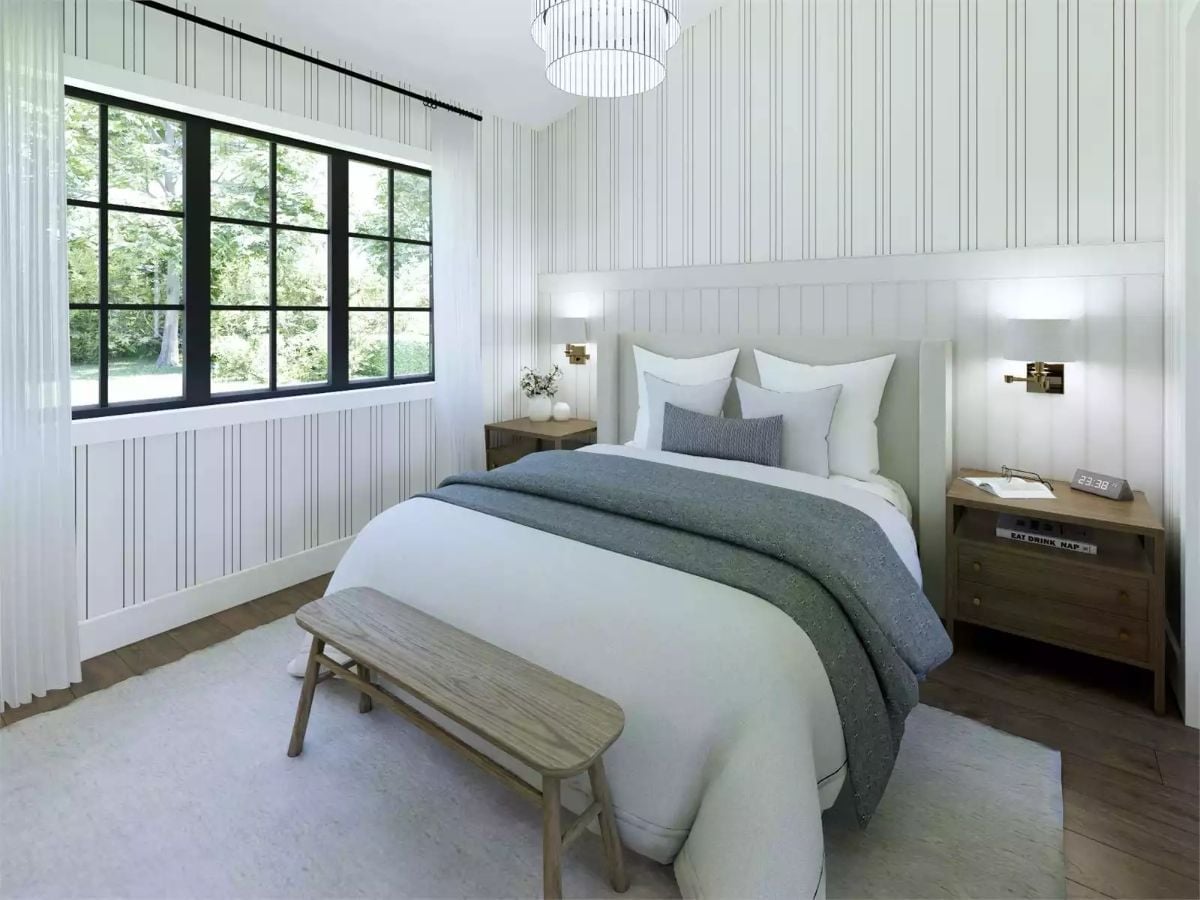Vertical Stripes and Brass Sconces Make a Bedroom Feel Taller Than It Is