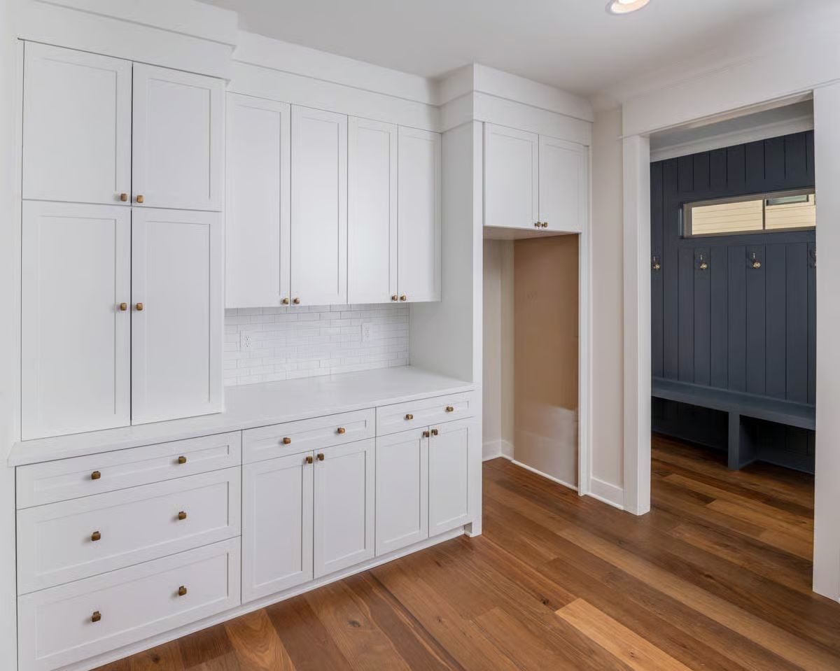 Built-In Storage Wall with Brass Hardware That Earns Its Keep