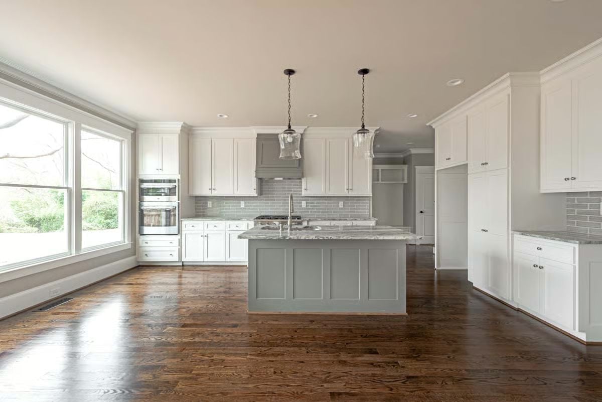 Gray Island, White Cabinets, and Pendant Lights That Actually Belong Here