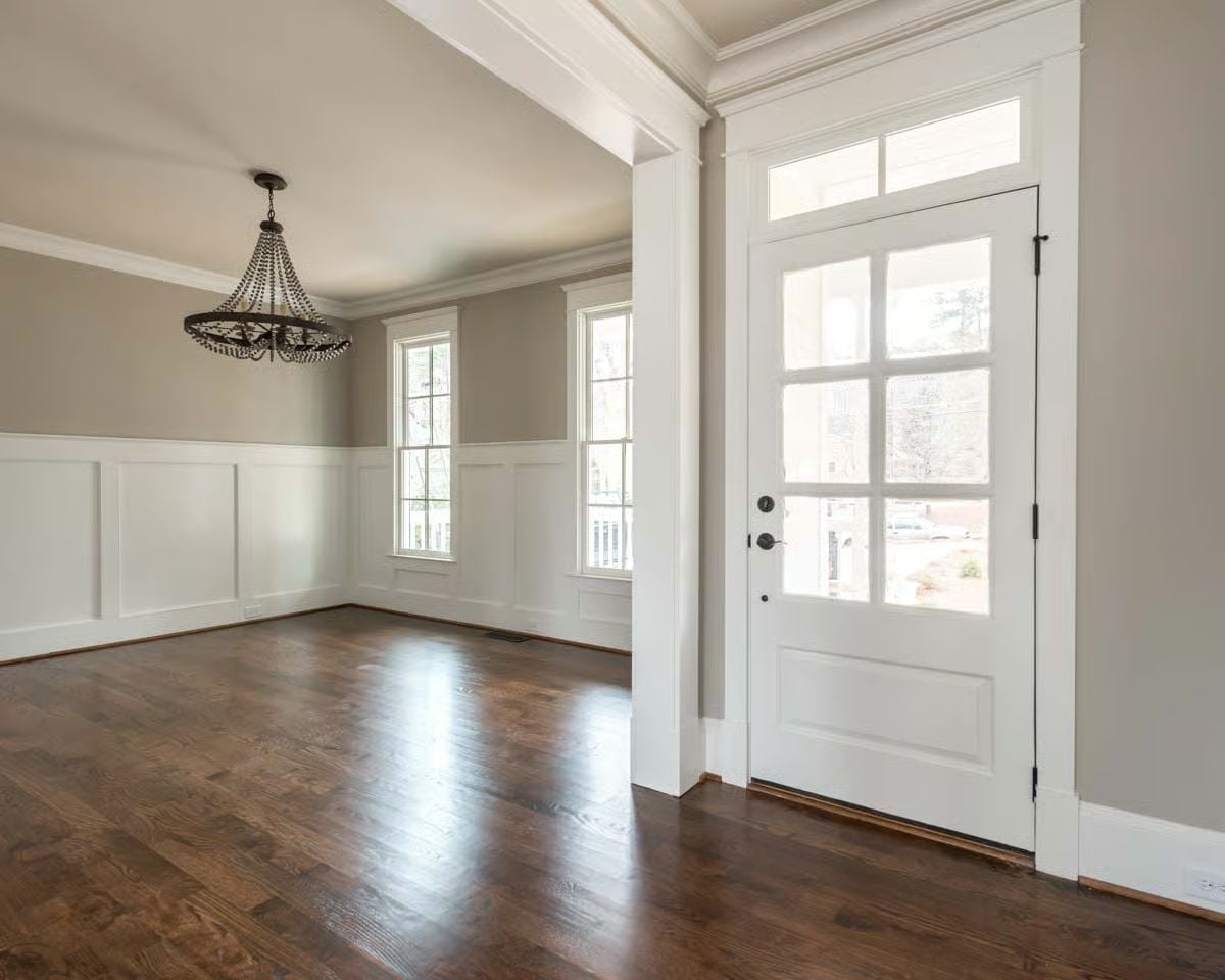 Wainscoting, Dark Floors, and a Chandelier That Means Business