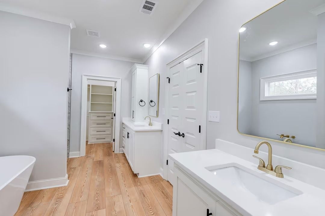 Dual Vanities and Gold Fixtures Make Separate Sinks Feel Like the Only Option