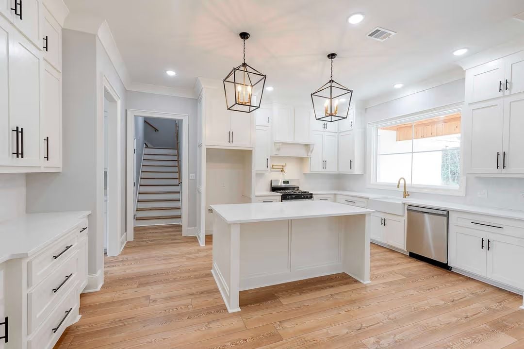 Lantern Pendants and Matte Black Hardware Keep White Kitchens from Going Soft
