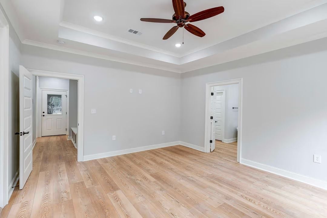 Tray Ceiling and Ceiling Fan Signal That This Primary Bedroom Means Business