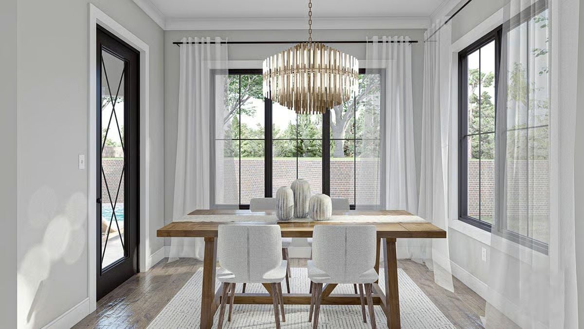 Brass Chandelier and Bare Wood Table Pull the Dining Room in Two Directions at Once