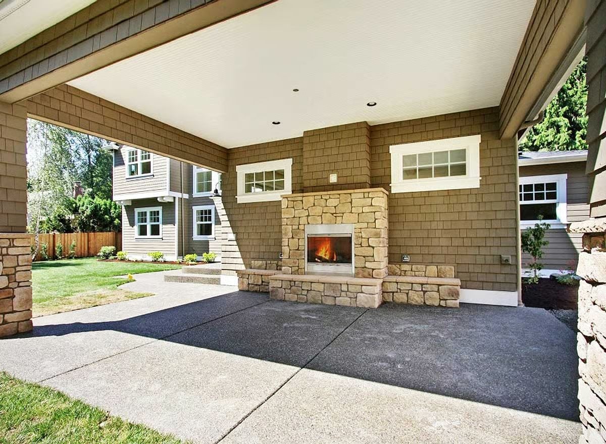 Covered Patio With a Stone Fireplace Built to Handle Year-Round Use