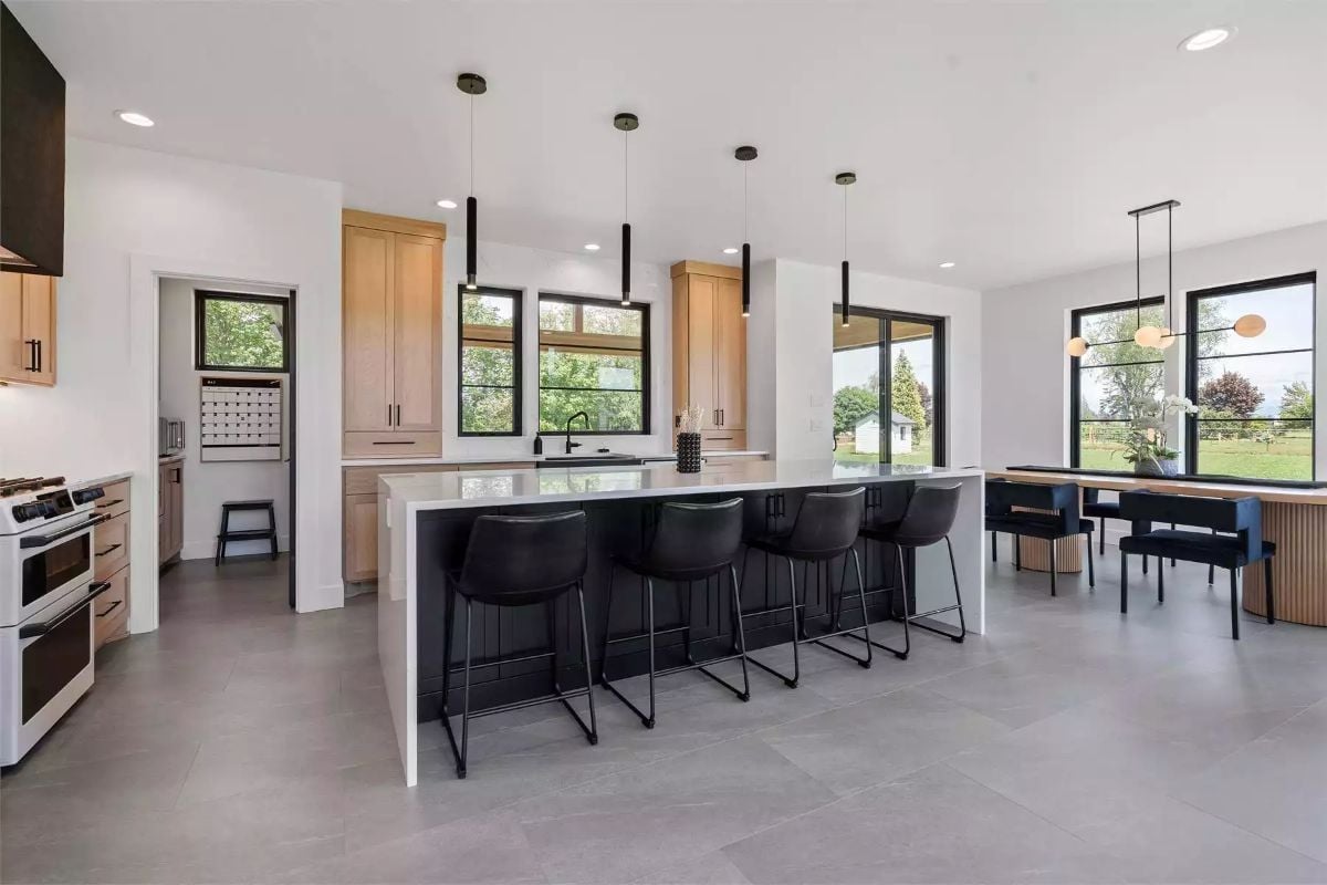 Black Barstools and Warm Wood Cabinets Pull This Kitchen in Two Directions at Once