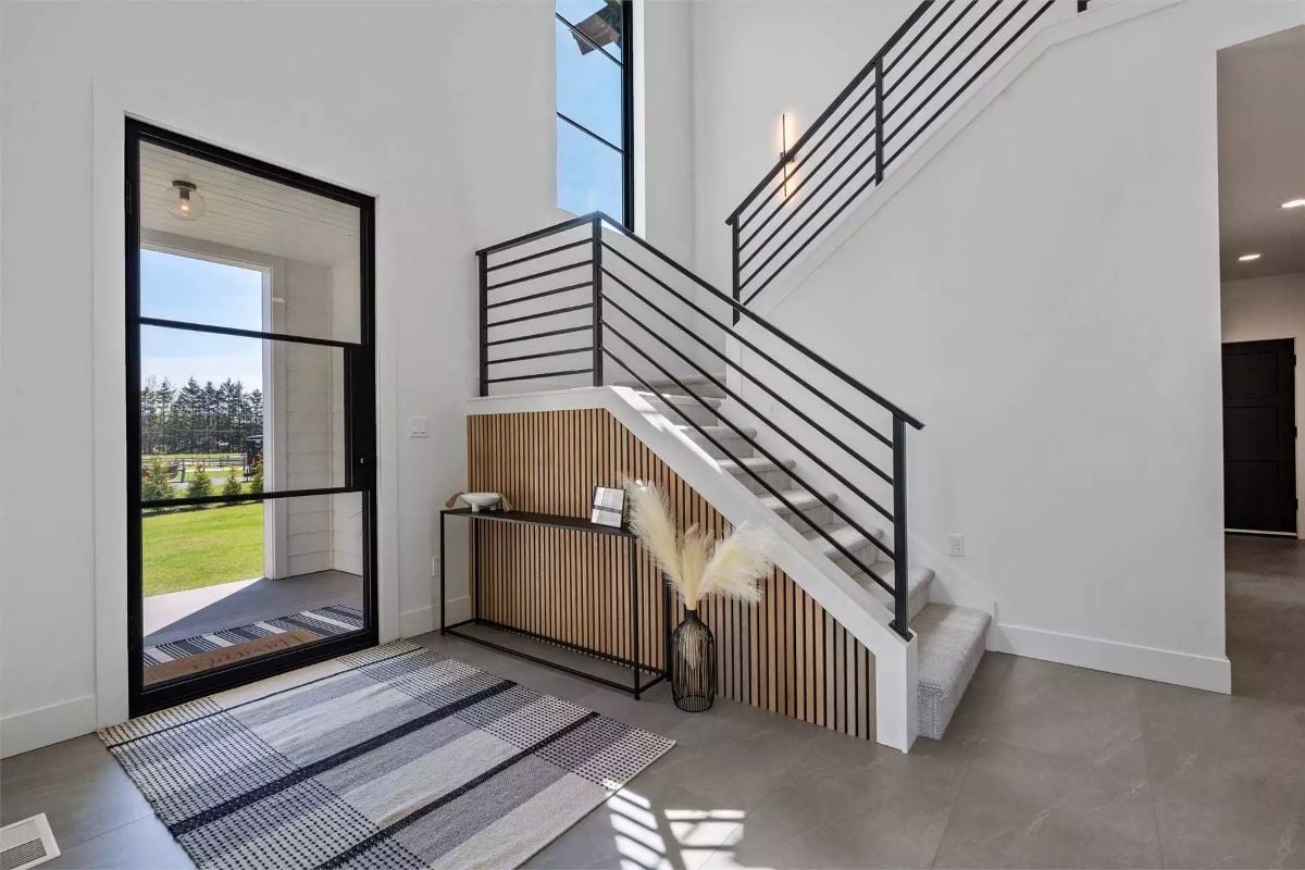 Vertical Height and Black Steel Make This Foyer Feel Earned