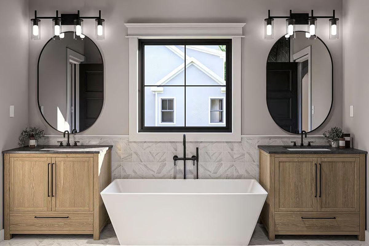 Dual Oak Vanities and a Freestanding Tub Centered on a Window Worth Framing
